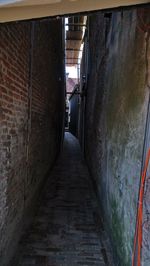 Narrow alley along walls and buildings