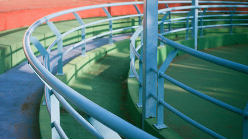 High angle view of empty deck chairs against railing