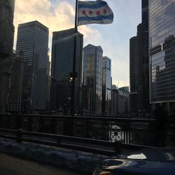 Buildings in city against cloudy sky