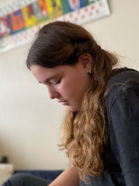 Portrait of young woman looking away at home