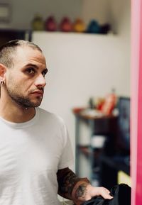 Young man looking at camera at home