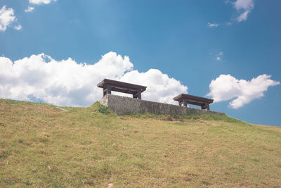 Built structure on field against sky