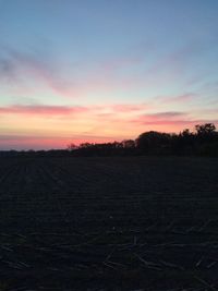 Scenic view of field against sky during sunset