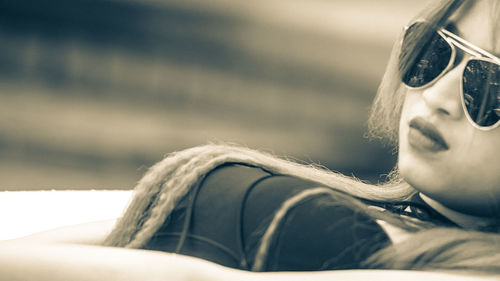 Close-up of young woman in sunglasses