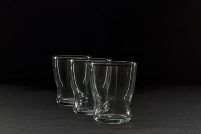 Close-up of empty glasses against black background