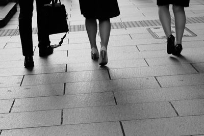 Low section view of business people walking together