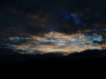 Scenic view of silhouette against sky at sunset