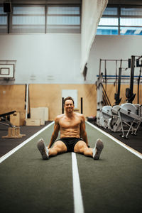 Full length of mature man sitting in room