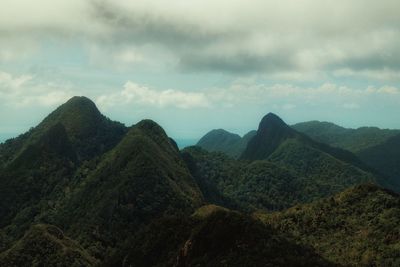 Scenic view of mountains against cloudy sky