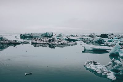 Scenic view of frozen lake against sky during winter