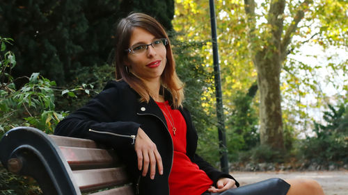 Portrait of woman sitting in park