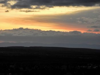 Scenic view of silhouette mountains against sky during sunset