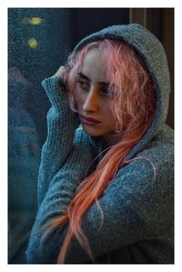 Close-up of thoughtful woman with pink hair