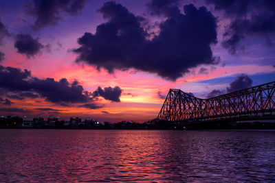 View of bridge over river during sunset