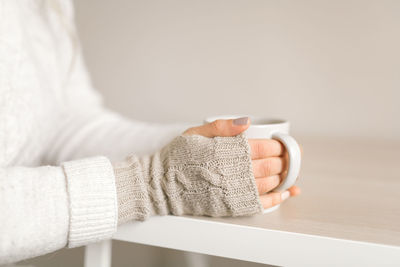 Close up of woman holding hot tea cup