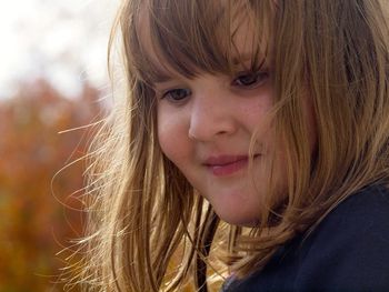 Close-up of smiling girl looking away