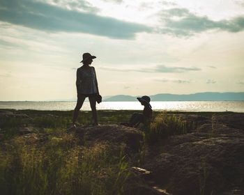 Man standing on beach against sky