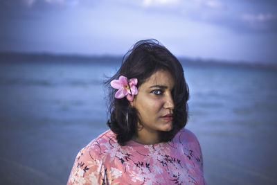 Portrait of woman against pink sea
