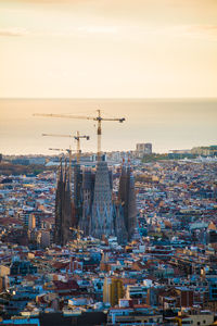 High angle view of buildings in city at sunset