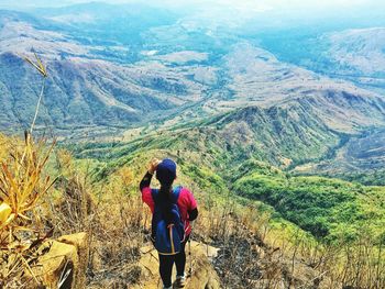 Rear view of woman looking at mountains