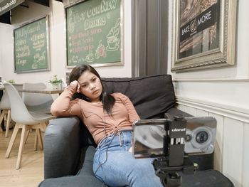 Portrait of woman sitting on sofa