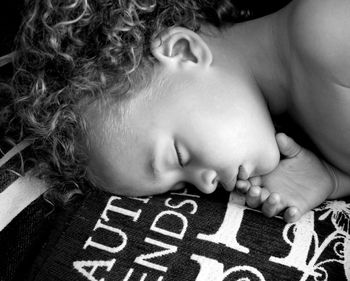 Close-up of young woman lying on bed