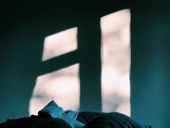 Low angle view of illuminated sign against sky at night