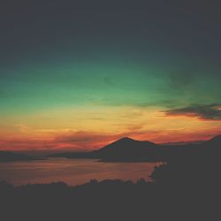 Scenic view of river at sunset