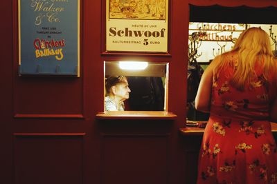 Rear view of woman standing in store