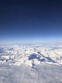 Scenic view of snowcapped mountain against blue sky