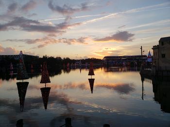 Reflection of buildings in water at sunset
