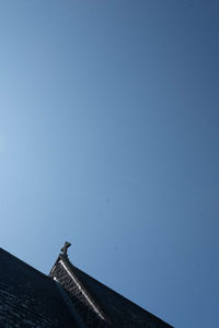 Low angle view of building against clear blue sky