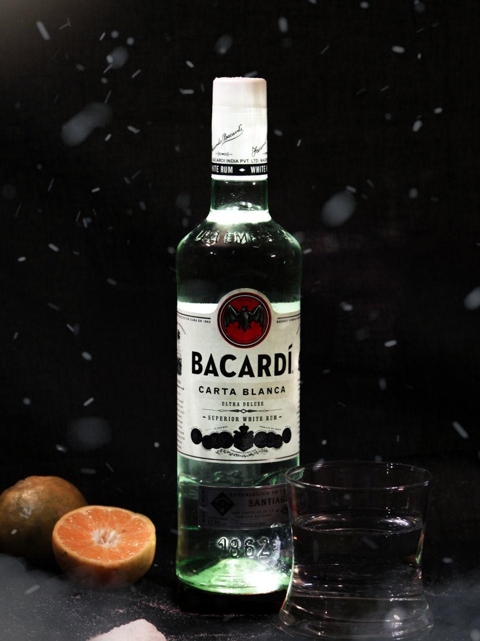 drink, distilled beverage, alcoholic beverage, food and drink, bottle, container, food, refreshment, black background, no people, glass, fruit, label, studio shot, freshness, indoors, alcohol, text, still life, whisky, healthy eating, communication