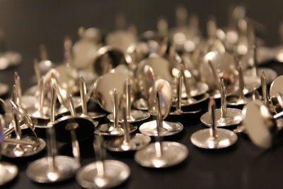 Close-up of thumbtacks on table
