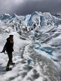 Woman standing on snow covered landscape 