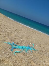 Blue sea shore at beach against sky