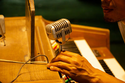 Close-up of man playing piano