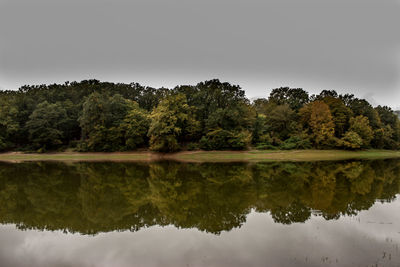 Reflection of trees in lake against sky