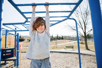 Portrait of girl hanging on bar