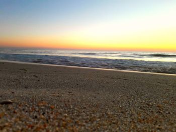 Scenic view of beach against sky during sunset