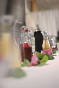 Close-up of flower bottles on table