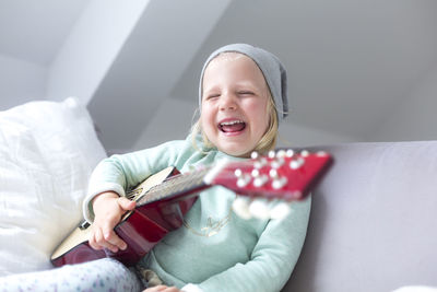 Smiling girl on bed at home