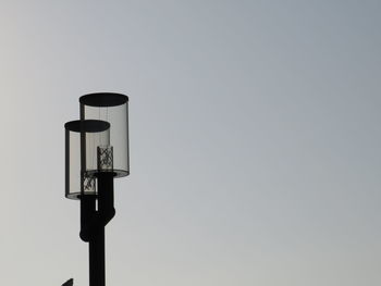 Low angle view of telephone pole against clear sky