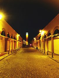 Empty illuminated street at night