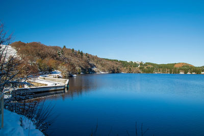 Scenic view of lake against clear blue sky