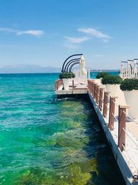 View of swimming pool by sea against sky