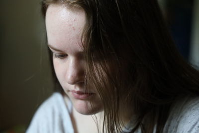 Close-up portrait of a beautiful young woman looking away