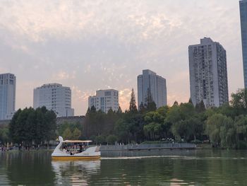 Scenic view of river and buildings against sky