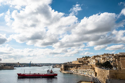 Panoramic view of sea and buildings against sky