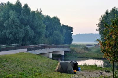 Bridge over canal with trees in background